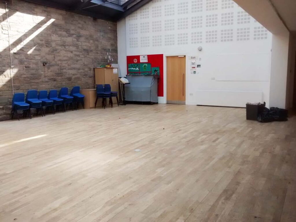 Centenary Hall: looking north east, with sanctuary wall on left. Note the covered piano by the door